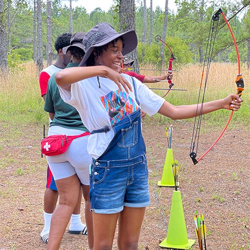 Girl with bow and arrow in Summer Camp